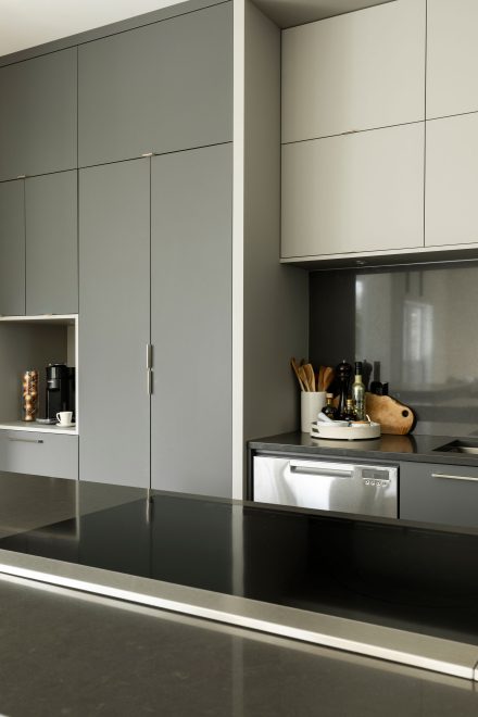 Modern interior of a spacious kitchen with a large island in the center.