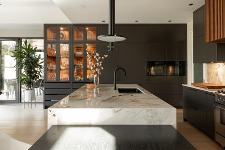 Chic kitchen with stunning countertops and subtle wooden details.