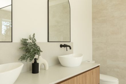 Custom made vanity from Atleliers Jacob with oak wood, and oval mirrors