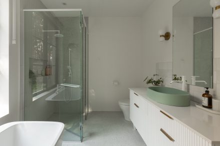 Salle de bain moderne signée Ateliers Jacob, avec douche vitrée, baignoire autoportante et vanité en latte de bois blanches.