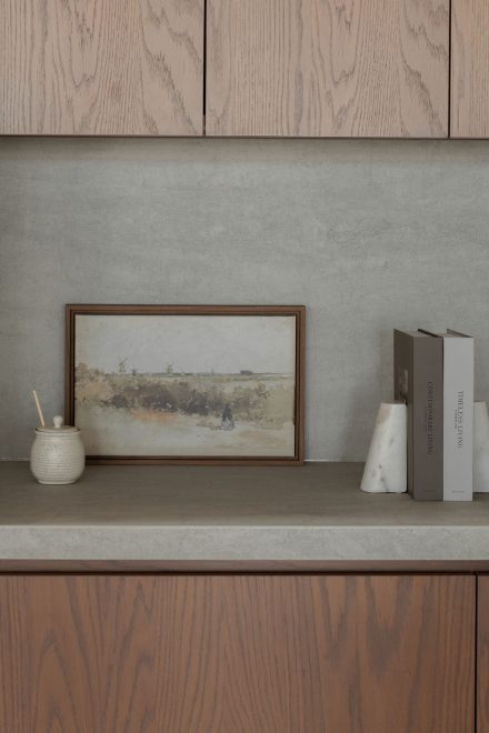 Détail du comptoir et du dosseret en porcelaine Laminam, en continuité avec les armoires en chêne de la collection Ateliers Jacob.