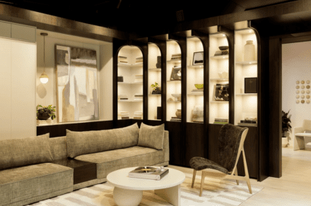Living space by Ateliers Jacob: backlit arched bookshelves, dark cabinetry and a cozy lounge corner create a warm, inviting atmosphere.